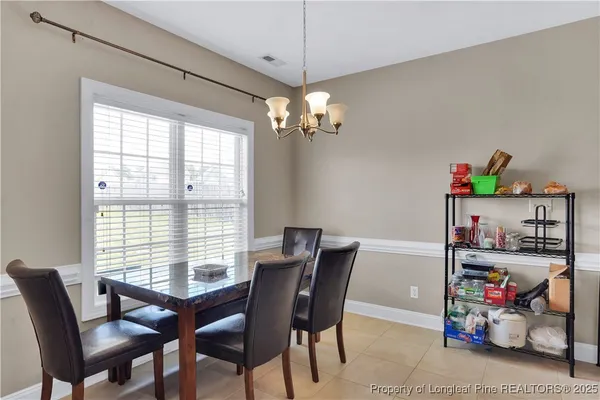 a view of a dining room with furniture and a window