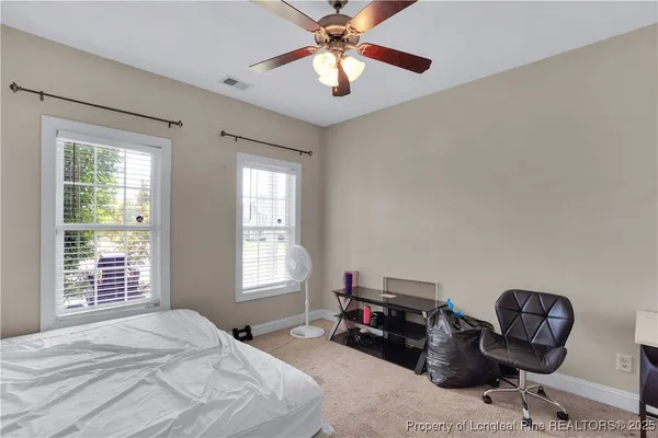 a bedroom with furniture and a window