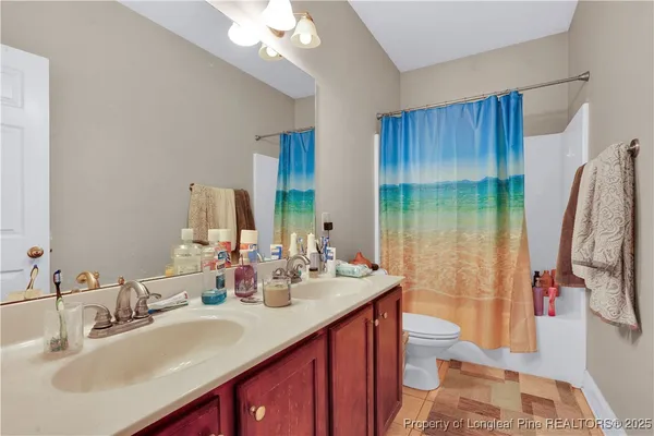 a bathroom with a double vanity sink a mirror and shower