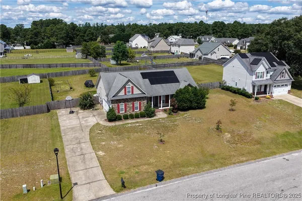 an aerial view of a house with a swimming pool