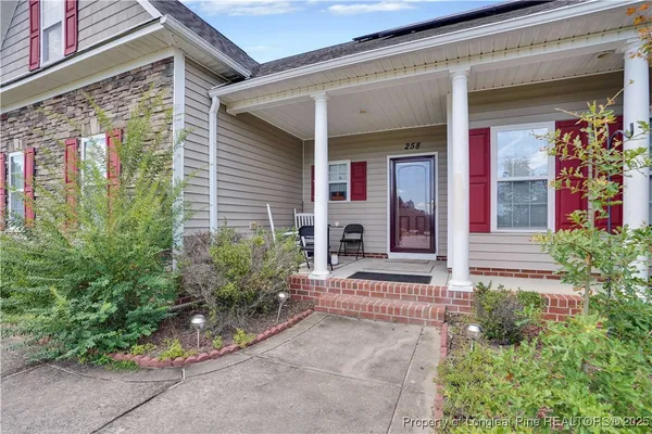 a view of house with outdoor space and porch