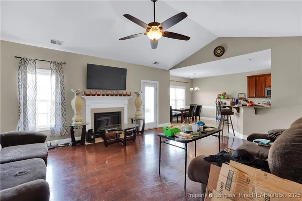 a living room with furniture fireplace and a flat screen tv