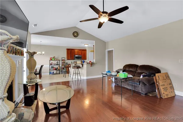 a living room with furniture and a wooden floor