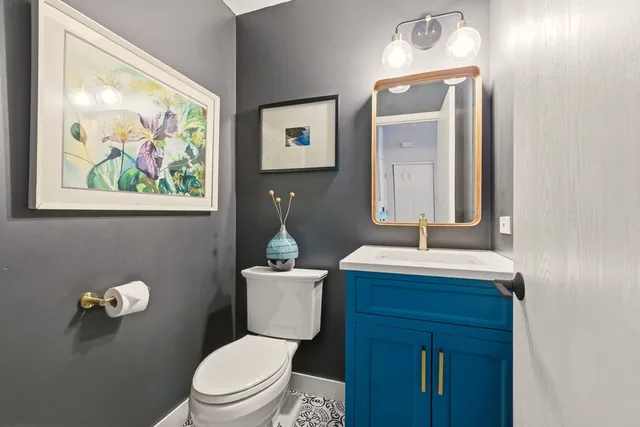 a bathroom with a toilet a sink and mirror