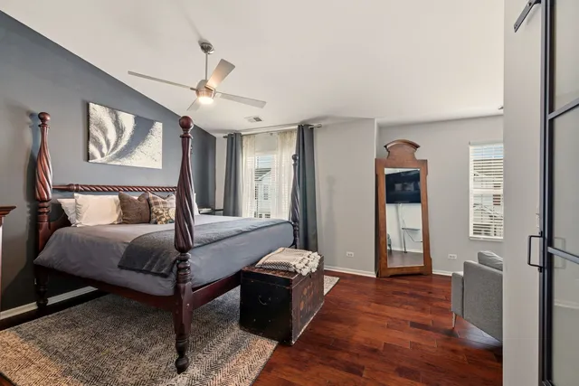 a bedroom with a bed and a chandelier