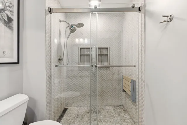 a bathroom with a glass shower door