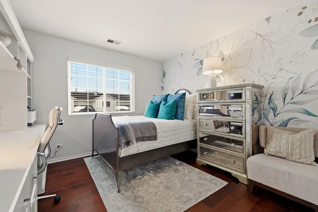 a bedroom with furniture and a wooden floor