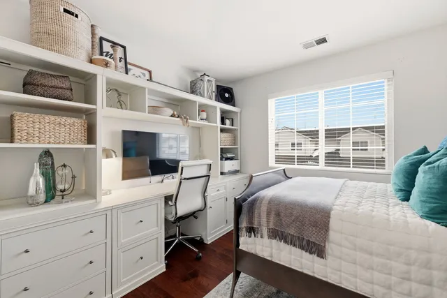 a large bed sitting in a bedroom next to a window