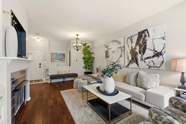 a living room with furniture kitchen view and a fireplace