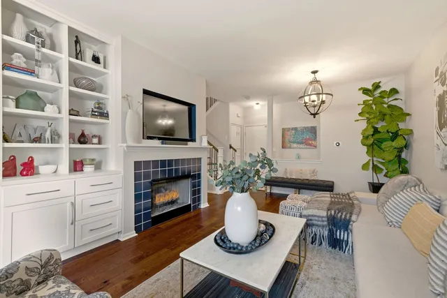 a living room with furniture fireplace and a potted plant