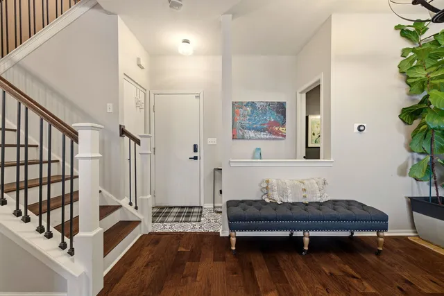 a living room with furniture wooden floor and a potted plant