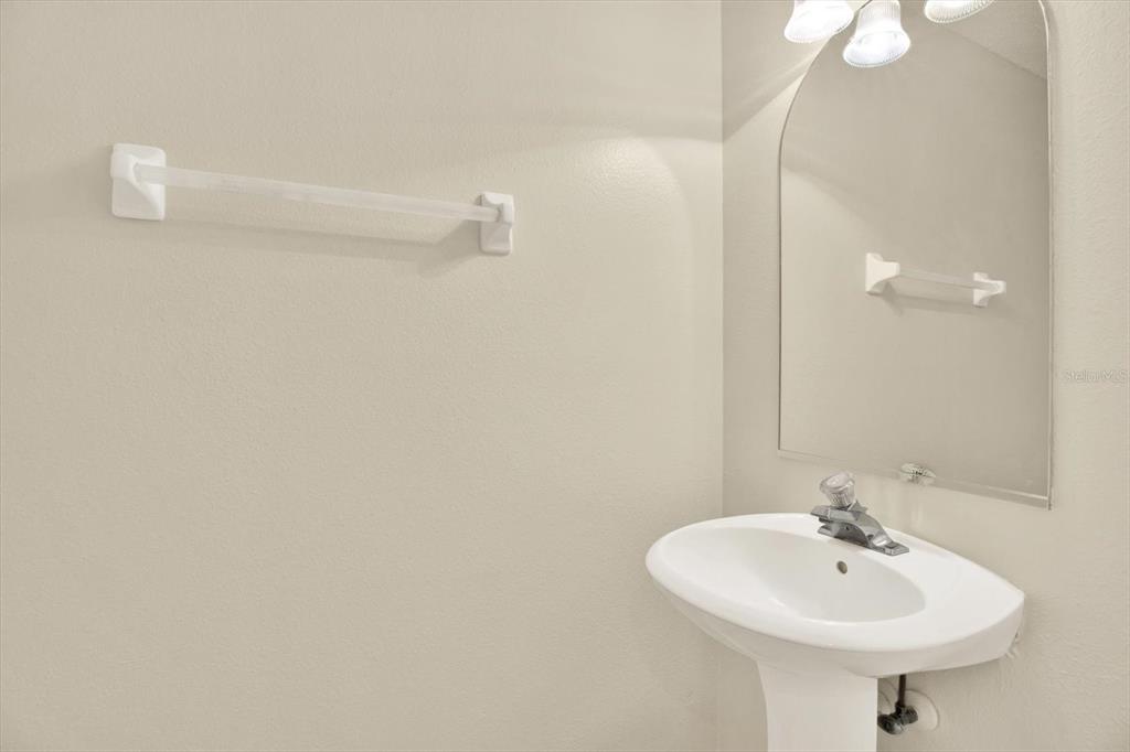 8541 Hunters Key Circle Tampa, FL 33647 - Photo 11 of 24 a bathroom with a sink a mirror and shower