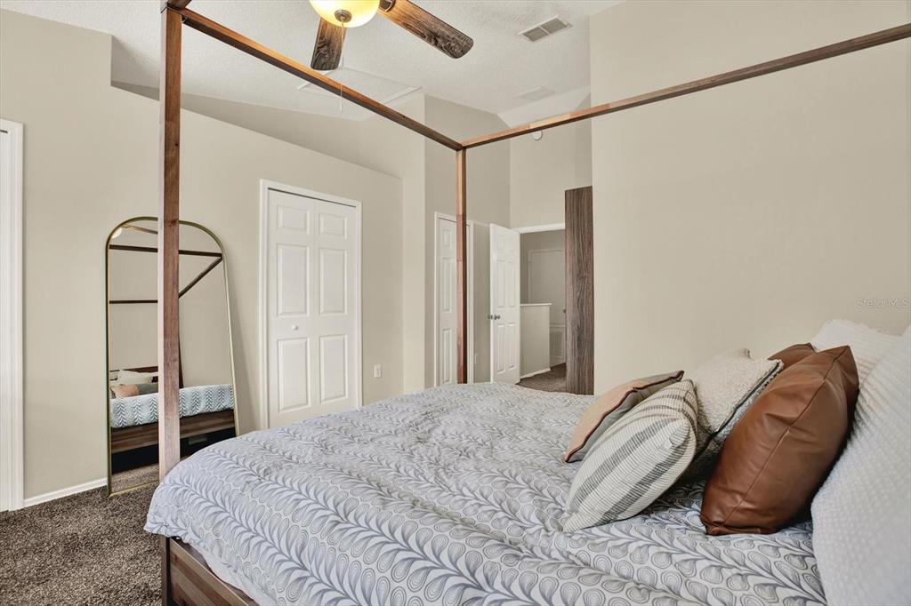 8541 Hunters Key Circle Tampa, FL 33647 - Photo 14 of 24 a bedroom with a bed and a chandelier