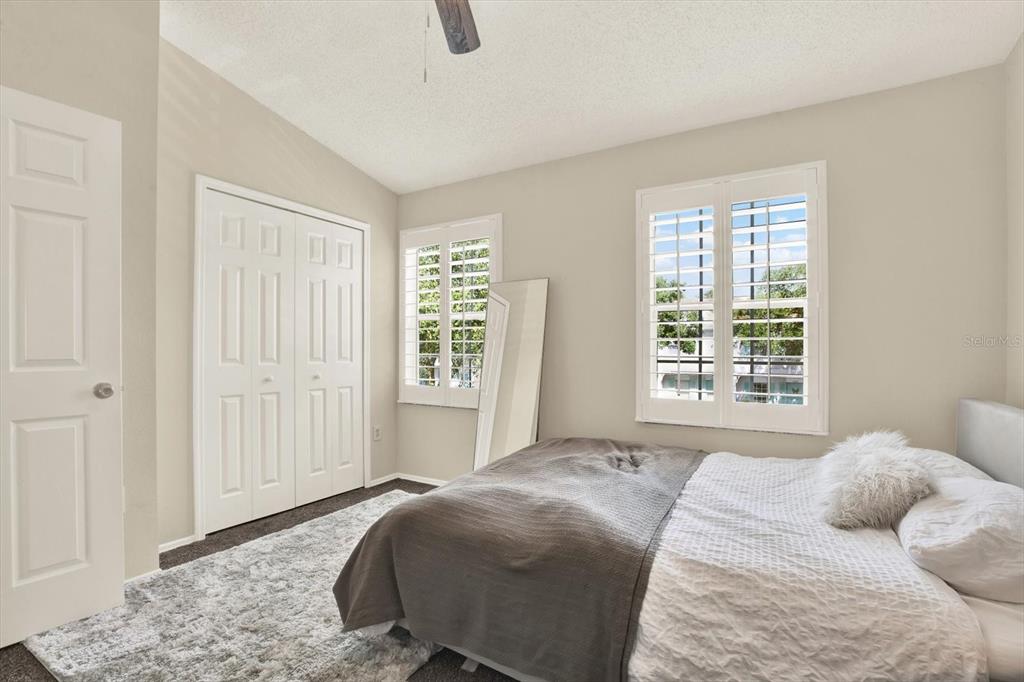 8541 Hunters Key Circle Tampa, FL 33647 - Photo 17 of 24 a bedroom with a bed and wooden floor