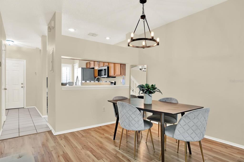 8541 Hunters Key Circle Tampa, FL 33647 - Photo 3 of 24 a view of a dining room with furniture and wooden floor