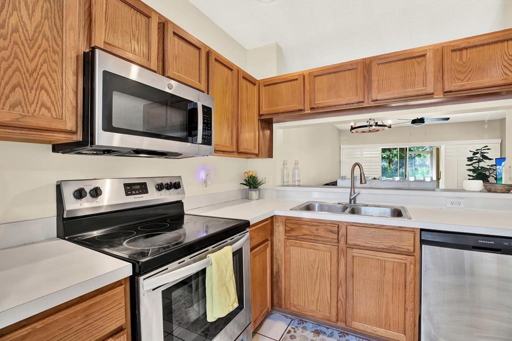 8541 Hunters Key Circle Tampa, FL 33647 - Photo 7 of 24 a kitchen with stainless steel appliances granite countertop a stove microwave and sink
