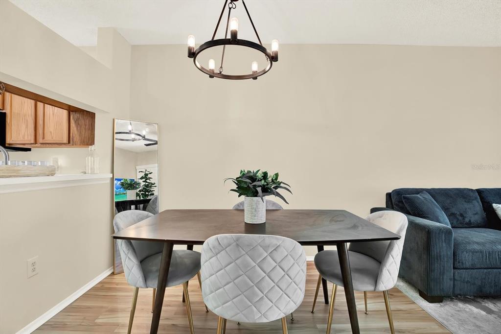 8541 Hunters Key Circle Tampa, FL 33647 - Photo 8 of 24 a view of a dining room with furniture and wooden floor