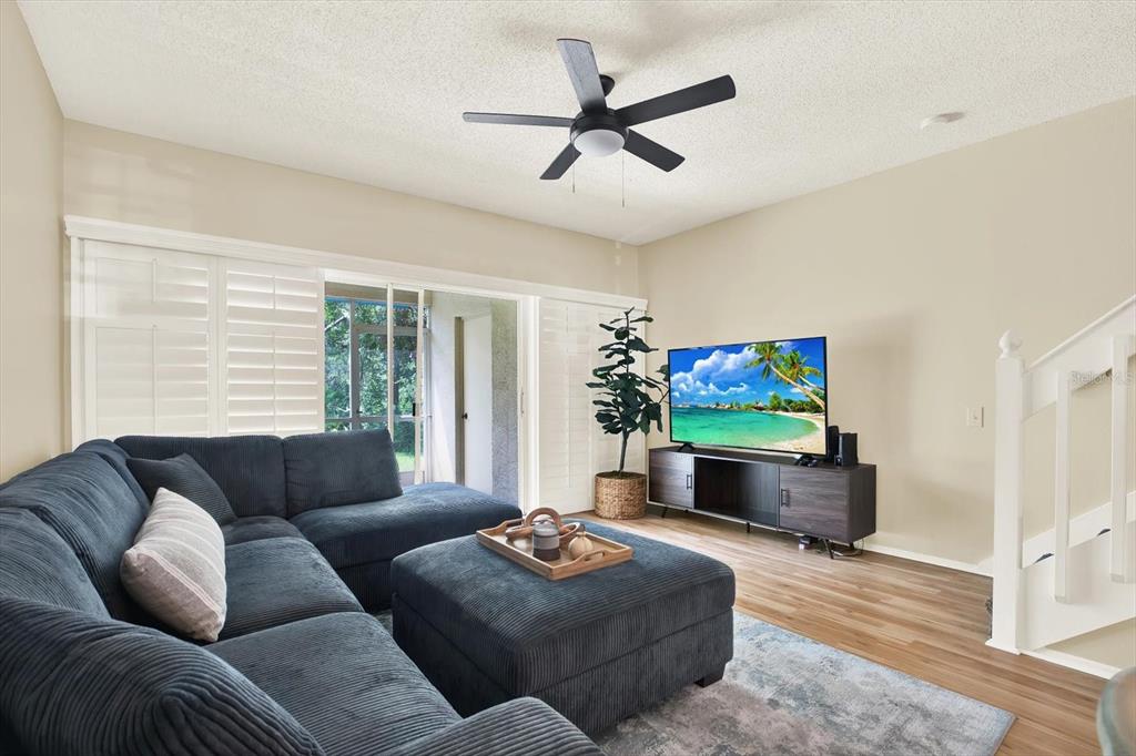 8541 Hunters Key Circle Tampa, FL 33647 - Photo 9 of 24 a living room with furniture and a flat screen tv