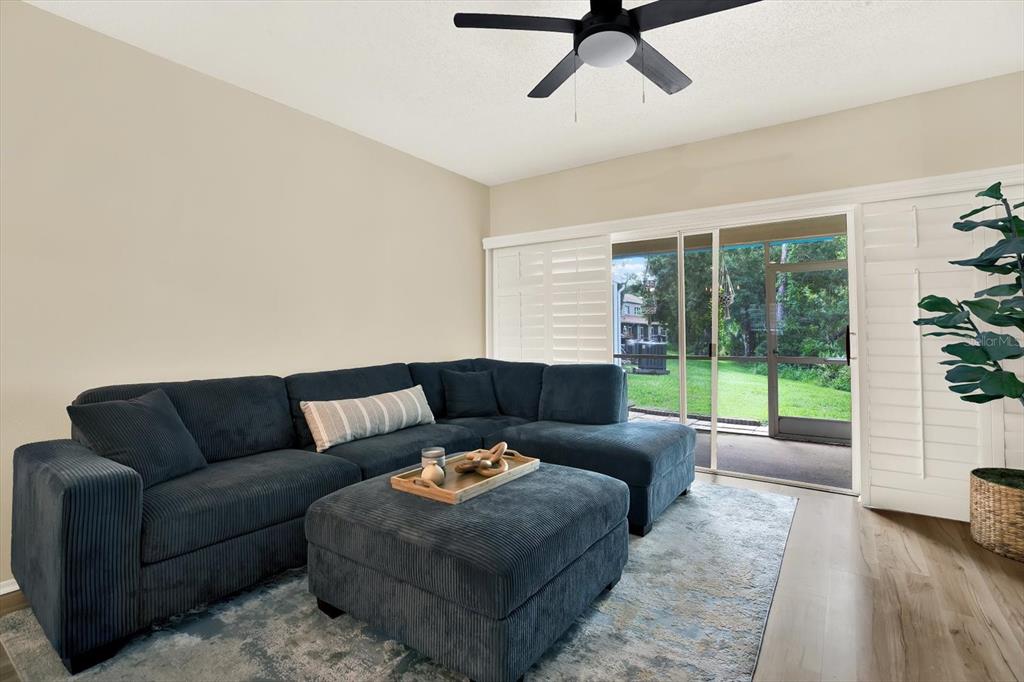 8541 Hunters Key Circle Tampa, FL 33647 - Photo 10 of 24 a living room with furniture and a floor to ceiling window