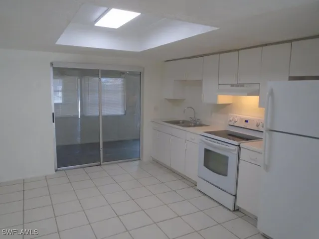 a kitchen with granite countertop a stove and a sink