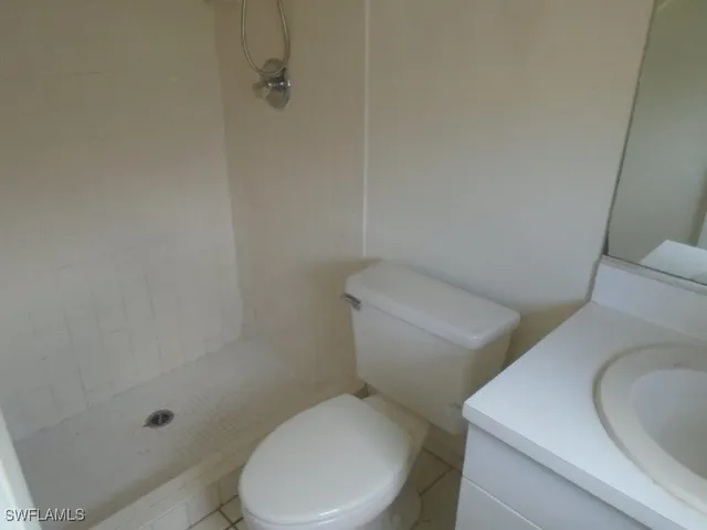 a white toilet sitting next to a bath tub