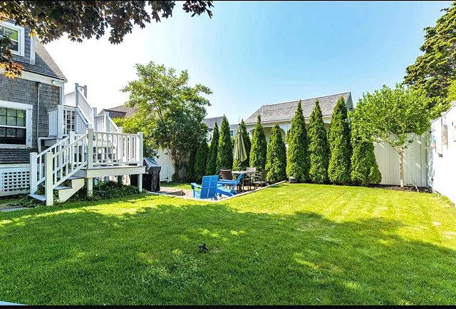 a view of a house with a yard porch and sitting area