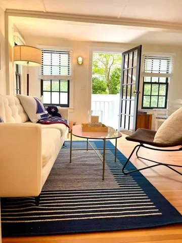 a living room with a couch a large window and a table