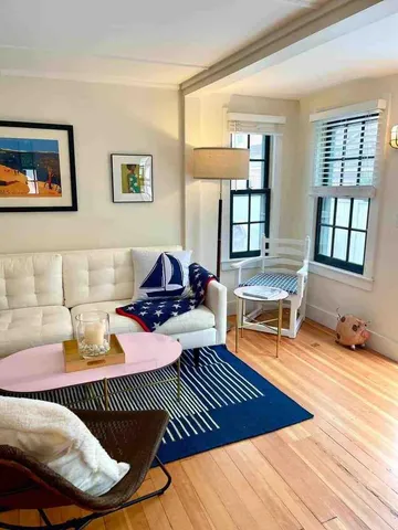 a living room with furniture rug and window