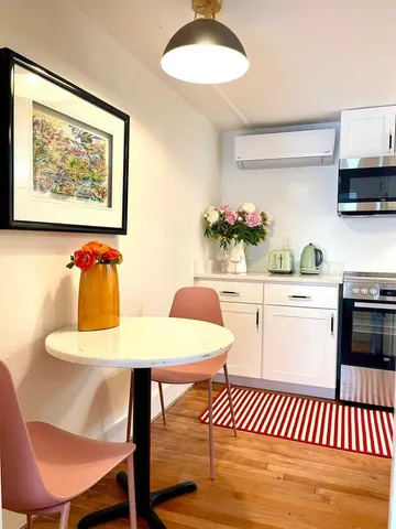 a kitchen with a table chairs and a dining table