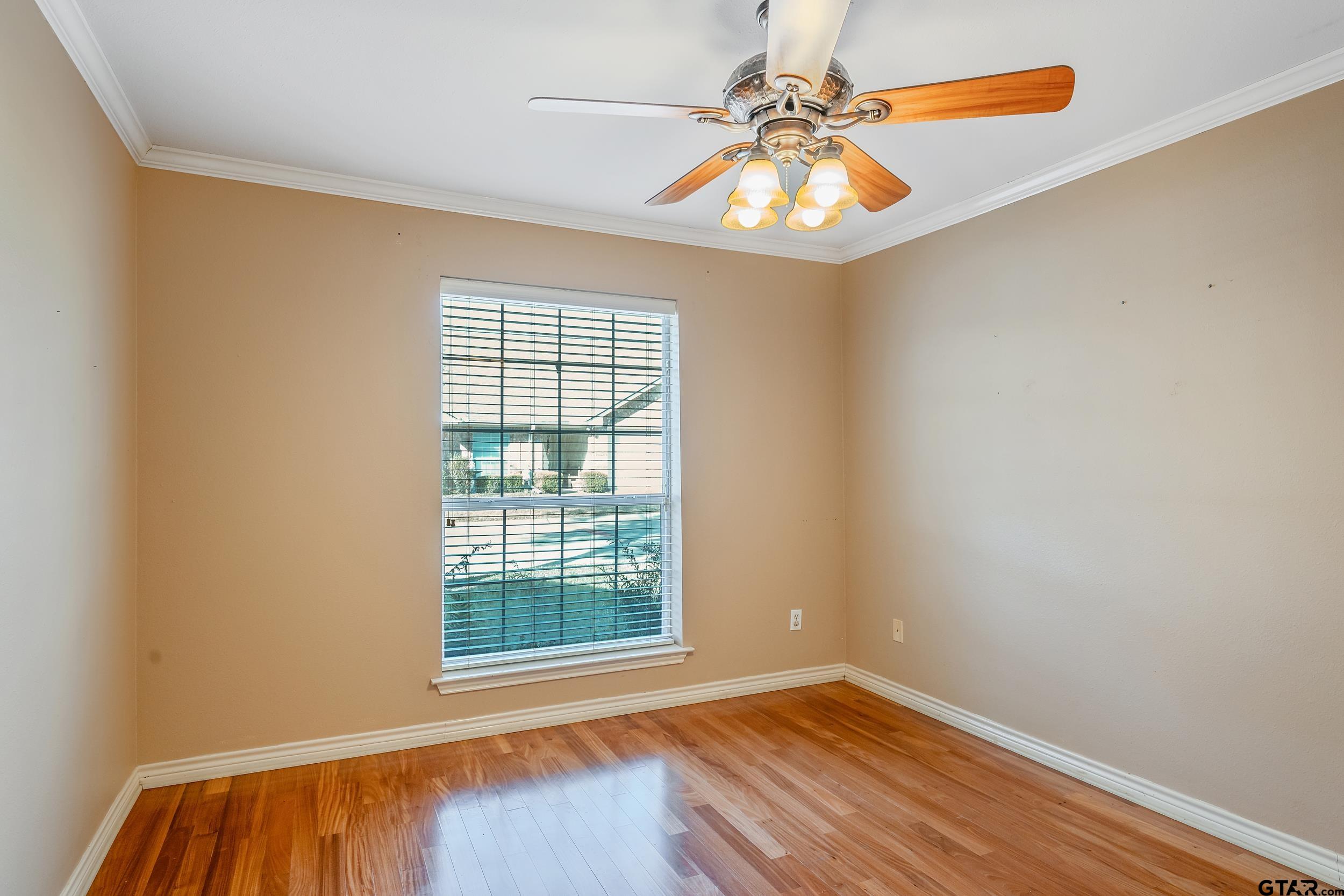 1202 Rice Road, Unit 135 Tyler, TX 75703 - Photo 17 of 21 an empty room with windows and fan