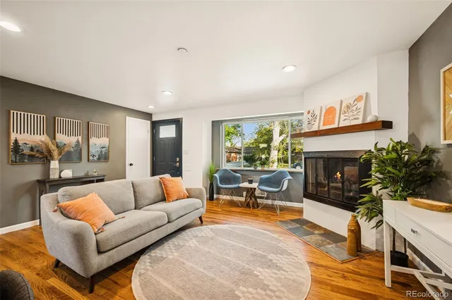 a living room with furniture a fireplace and a flat screen tv