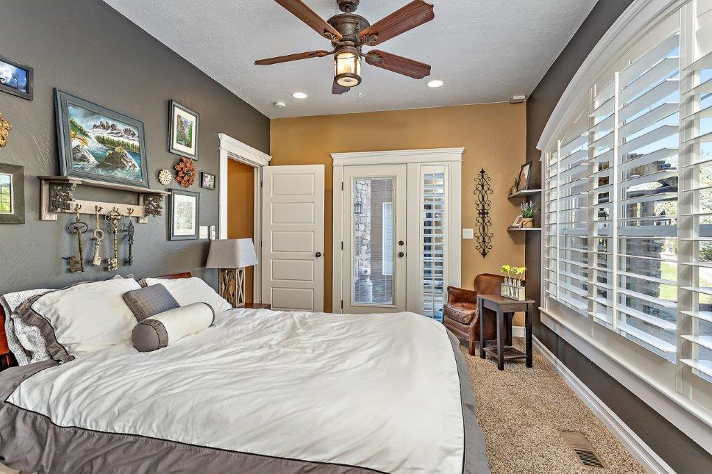 7652 Old Stage Road Central Point, OR 97502 - Photo 15 of 34 a bedroom with a large bed and a chandelier