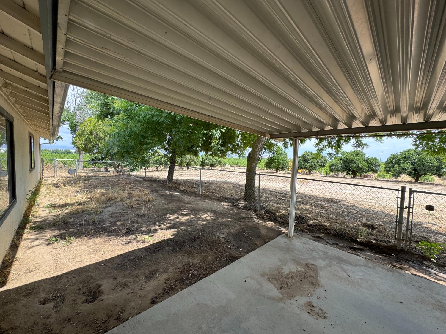 21293 East American Avenue Reedley, CA 93654 - Photo 14 of 19 a view of a backyard with wooden fence