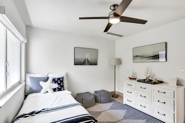 a bedroom with furniture and a flat screen tv