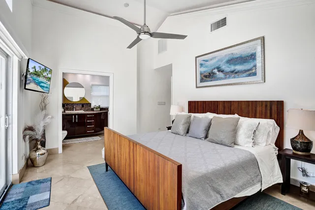 a bedroom with a bed and a chandelier