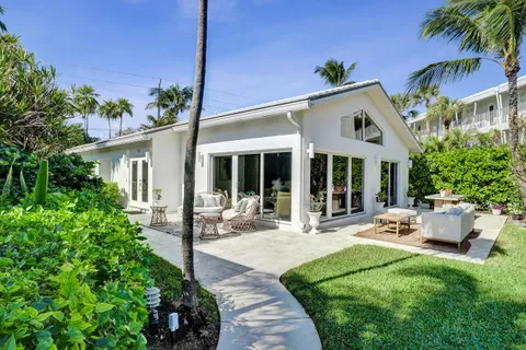 a front view of a house with garden and porch