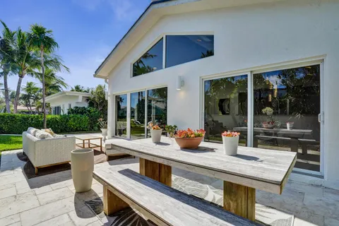 a view of a patio with couches and potted plants