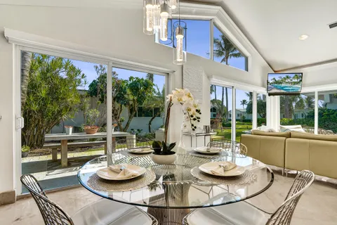 a dining room with furniture a large window and a table