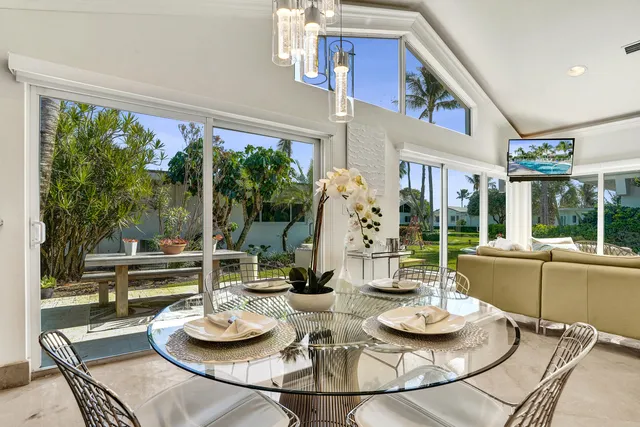 a dining room with furniture a large window and a table