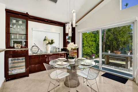 a dining room with furniture a rug and a large window