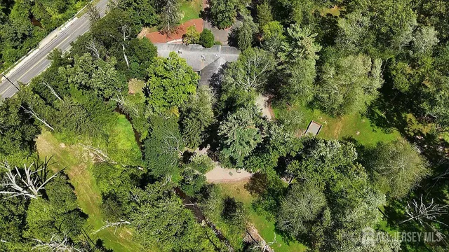 an aerial view of residential house with swimming pool and lawn chairs