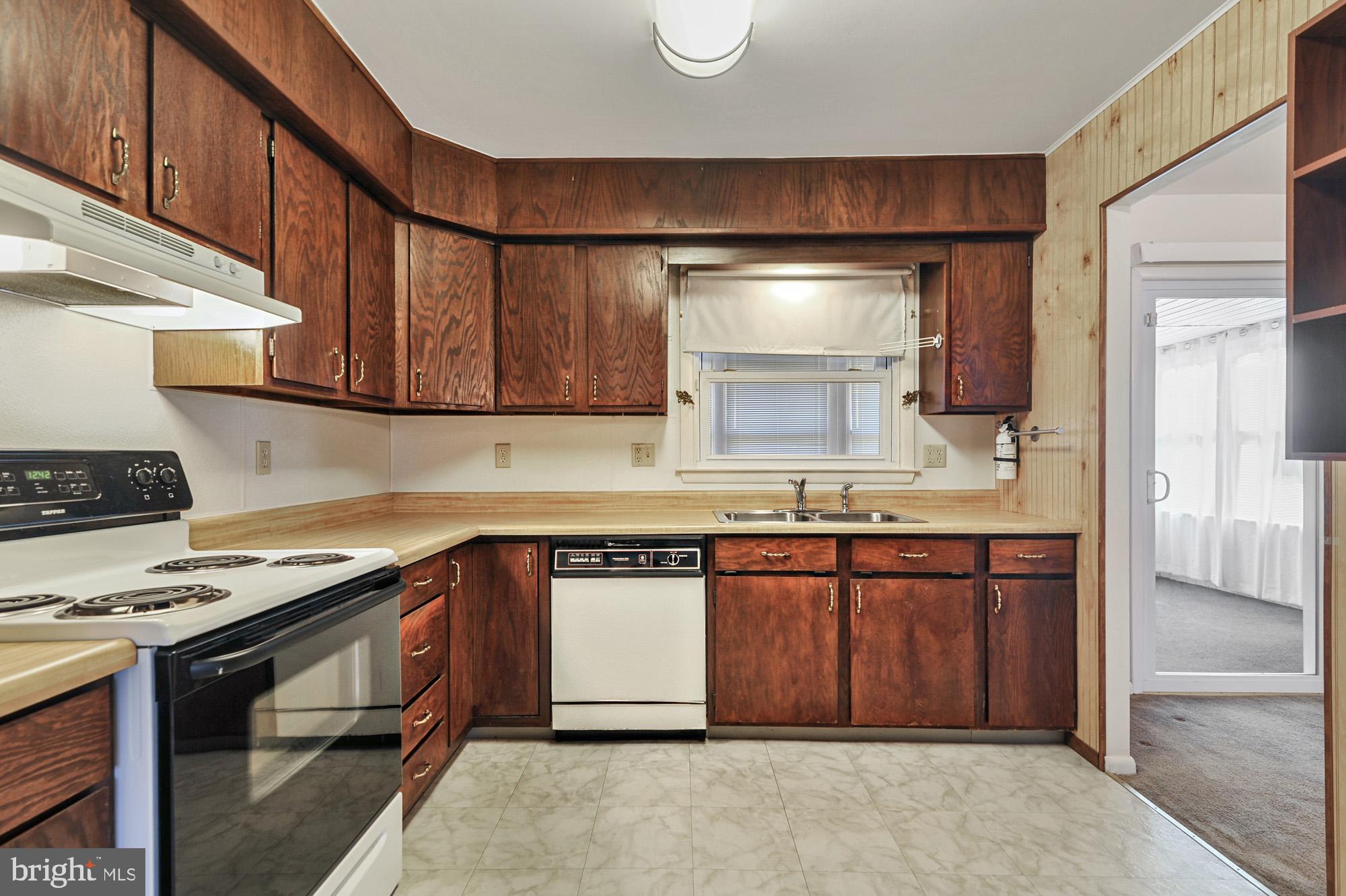 90 Katherine Drive Dover, DE 19901 - Photo 9 of 26 a kitchen with stainless steel appliances granite countertop a sink stove and cabinets