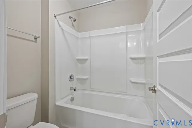 a bathroom with a bathtub and a toilet