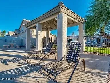 a view of a house with wooden deck and furniture