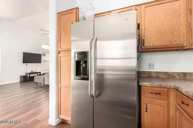 a kitchen with stainless steel appliances a refrigerator and cabinets