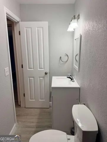 a view of empty room with wooden floor and window