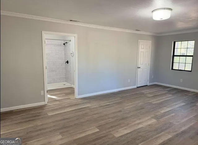 a view of a hallway with wooden floor