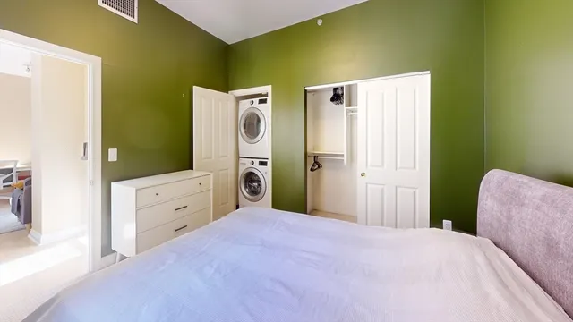 a bedroom with a bed and a dresser