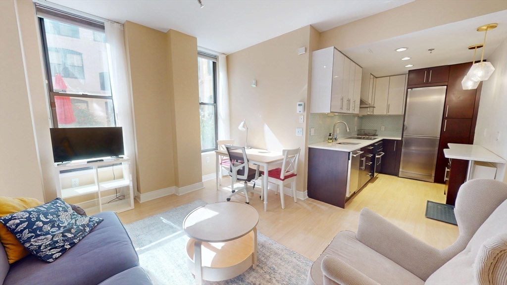 4 Charlesgate East, Unit 107 Boston, MA 02215 - Photo 7 of 23 a living room with furniture and a flat screen tv