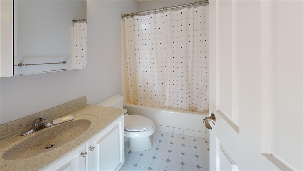 4 Charlesgate East, Unit 107 Boston, MA 02215 - Photo 8 of 23 a bathroom with a sink toilet and shower